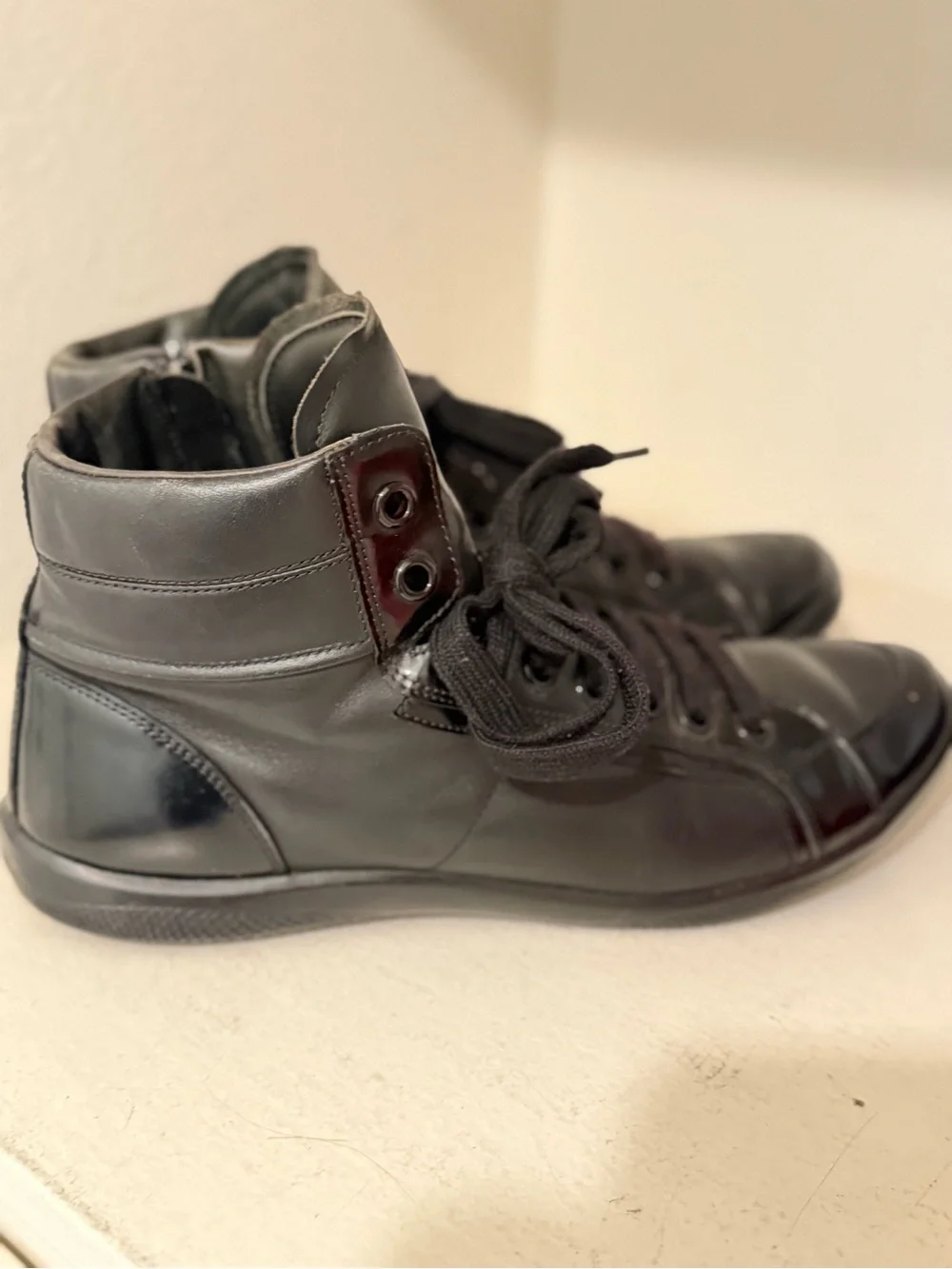 Authentic Prada Black High-Top Leather Sneakers with Red Logo